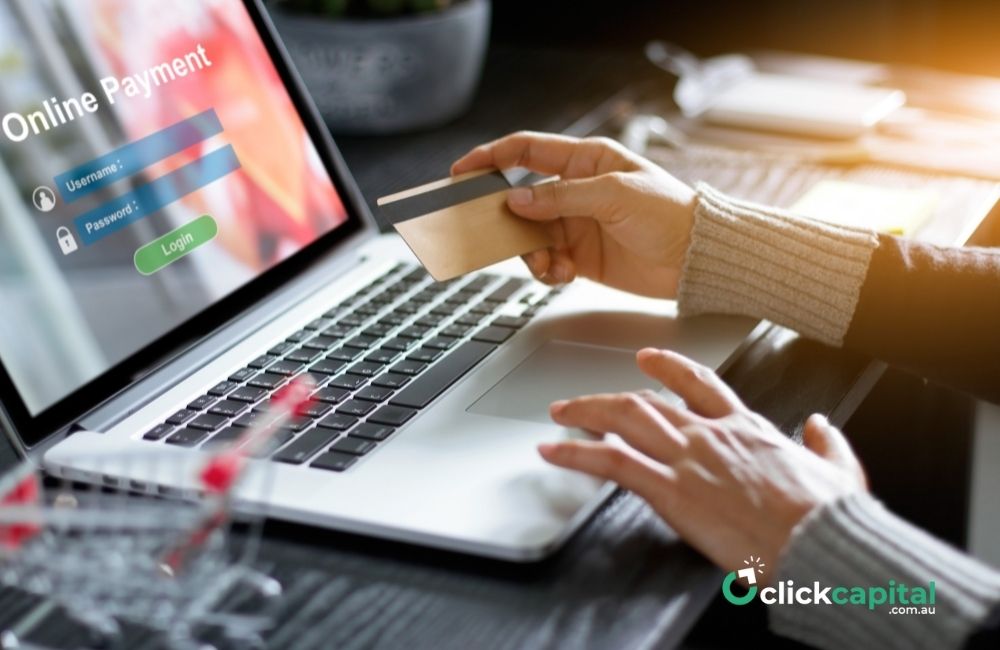 hand of a businessman doing online payment while holding a credit card