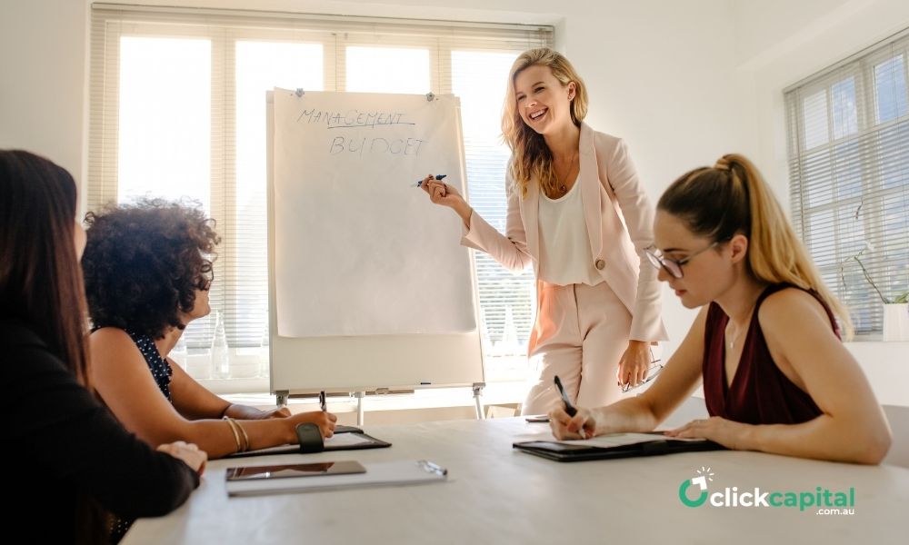 Woman Giving Presentation on Budget to her employees