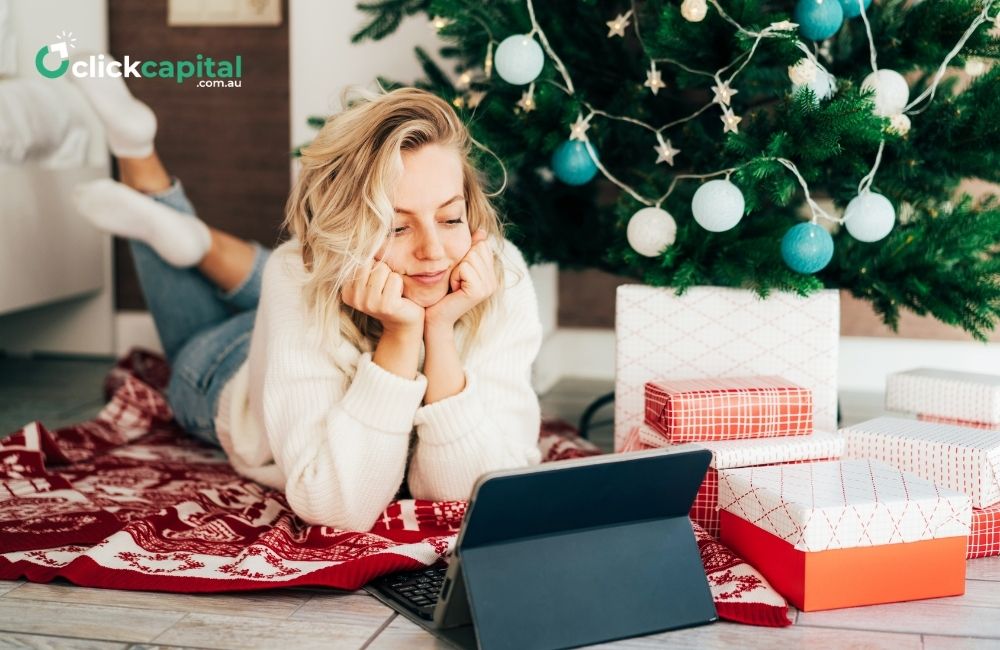 business woman using laptop under the christmas tree