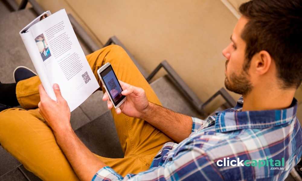 man scanning a QR code in the brochure from his smart phone