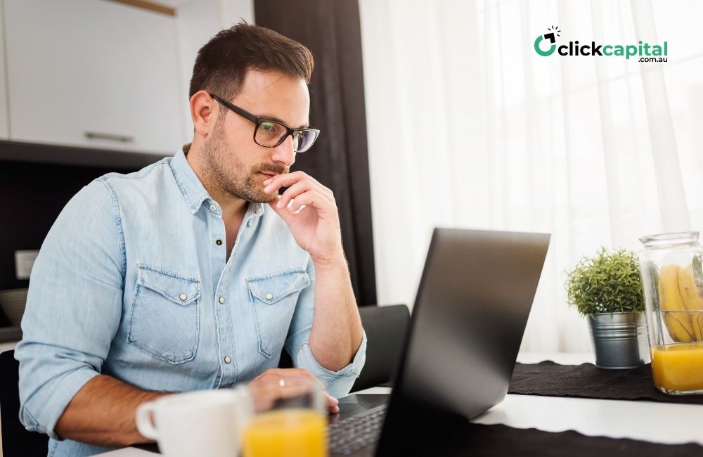 business owner comparing business loans in his laptop