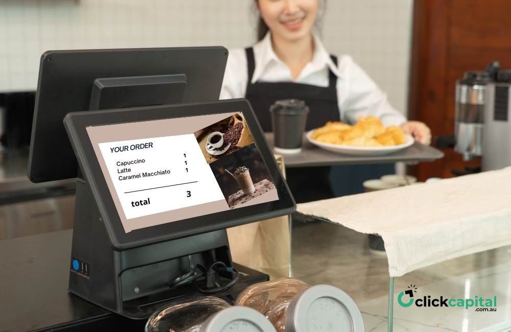 Woman barista in apron working on customer facing display with itemized order on monitor on counter, cafe restaurant cashier.