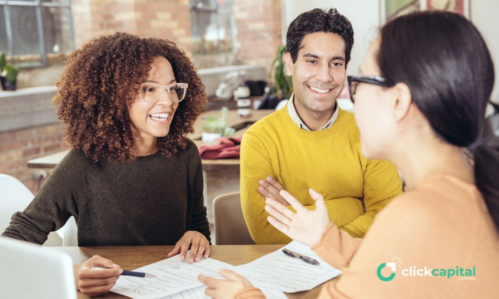 two business owners discussing loan contract with a finance broker